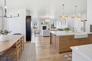 Kitchen featuring open floor plan, decorative light fixtures, a chandelier, light wood-style flooring, and recessed lighting