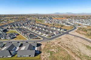 Aerial view of property and surrounding area with nearby suburban area