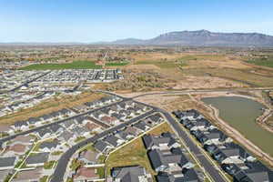 Aerial view of property and surrounding area with nearby suburban area and a water and mountain view