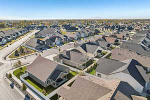 Aerial view of property and surrounding area featuring nearby suburban area