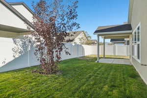 Fenced backyard with a patio