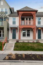 View of front facade featuring a standing seam roof, stucco siding, and a shingled roof