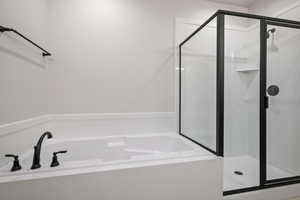 Full bath with a shower stall and a garden tub