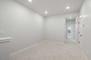Spare room with light carpet and recessed lighting