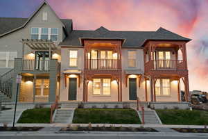View of front of house featuring a shingled roof, stucco siding, a balcony, and a porch