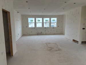 Empty room featuring wallpapered walls