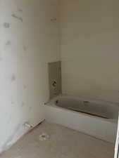 Bathroom featuring light tile patterned floors and a bath
