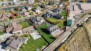 Aerial view of property and surrounding area with nearby suburban area