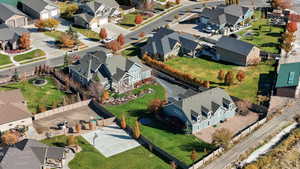 Aerial view of property and surrounding area featuring nearby suburban area