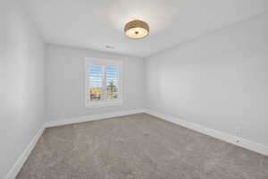 Unfurnished room with baseboards and carpet