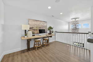 Loft  area featuring light wood-style floors, recessed lighting, and a textured ceiling