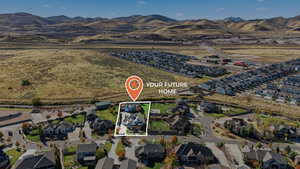 Aerial view of property and surrounding area with nearby suburban area and mountains