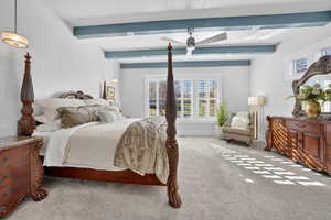 Priamry bedroom featuring beam ceiling and a ceiling fan