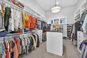 Primary Walk in closet with light colored carpet