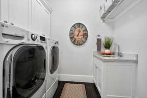 Laundry area with cabinet space and washing machine and dryer