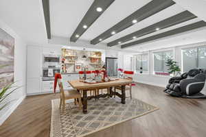 Dining room featuring light wood finished floors, beam ceiling, and recessed lighting