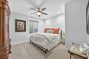 Bedroom with light colored carpet, ceiling fan, recessed lighting, and a textured ceiling