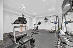 Gym featuring rubber floors and recessed lighting