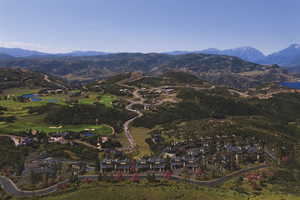 View of mountain backdrop with a nearby body of water, nearby suburban area, and a local golf course