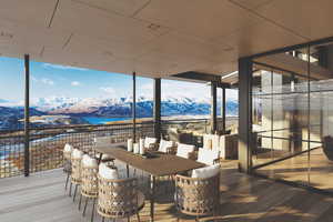 Wooden deck featuring a mountain view, outdoor dining area, and a patio