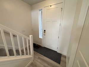 Foyer entrance featuring wood finished floors and stairway