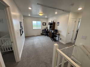 Office with carpet, recessed lighting, and a textured ceiling