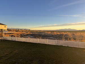 Yard at dusk featuring a mountain view
