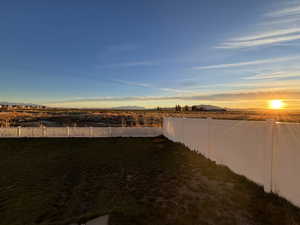 Fenced backyard with a mountain view