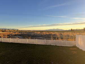 Yard at dusk featuring a mountain view