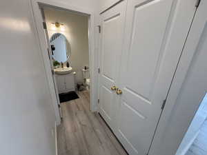 Hall featuring light wood-type flooring and a sink