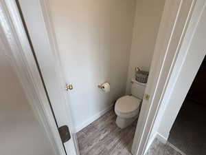 Bathroom featuring baseboards and light wood-style floors
