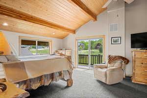 Bedroom with a wooden ceiling with exposed beams, carpet, access to exterior, ceiling fan, and multiple windows