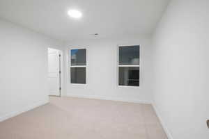 Spare room with light colored carpet