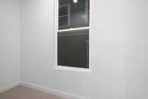 Detailed view of carpet floors and baseboards