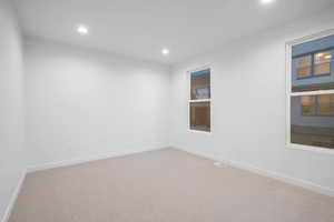 Spare room featuring recessed lighting and light colored carpet