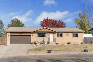 Ranch-style home featuring concrete driveway, a garage, and brick siding