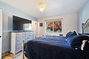 Bedroom featuring light wood-style floors and baseboards