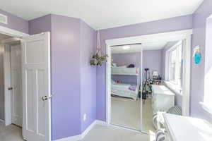Bathroom with light colored carpet and baseboards