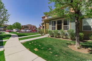View of front of property featuring a front yard, a porch, and a residential view