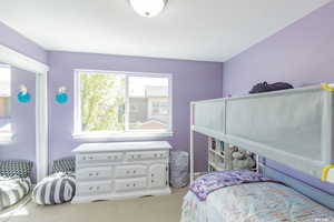Bedroom featuring light colored carpet