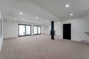 Spare room with recessed lighting and light colored carpet
