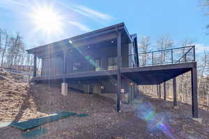 Back of property featuring a wooden deck