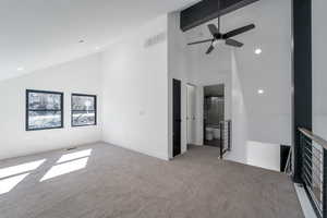Unfurnished living room with high vaulted ceiling, light colored carpet, ceiling fan, recessed lighting, and beamed ceiling