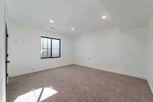 Spare room with recessed lighting and carpet