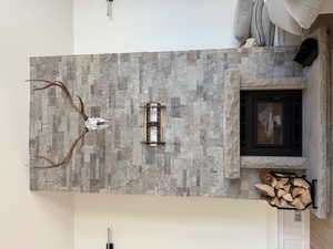 Detailed view of a stone fireplace and a decorative wall