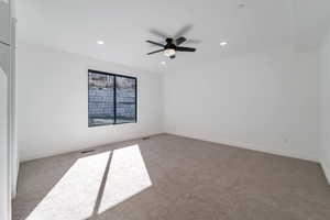Carpeted spare room featuring recessed lighting and a ceiling fan