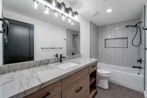 Full bathroom with vanity, shower / bath combination, recessed lighting, and light tile patterned floors