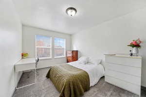 Bedroom with carpet flooring and baseboards