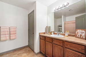Full bath with vanity and a shower with shower curtain