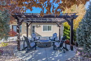 View of patio featuring a pergola and a fire pit